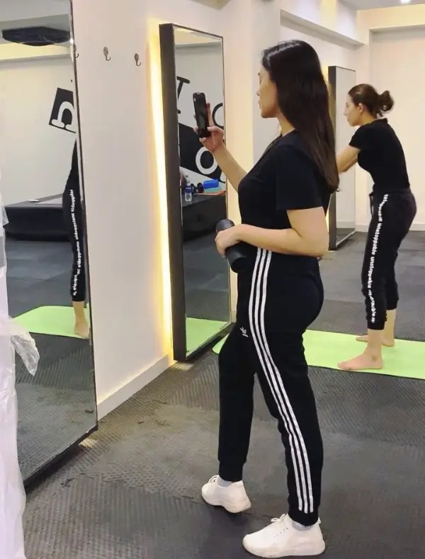 An image illustration shows Warisha Javed Khan exercising in gym clothing
